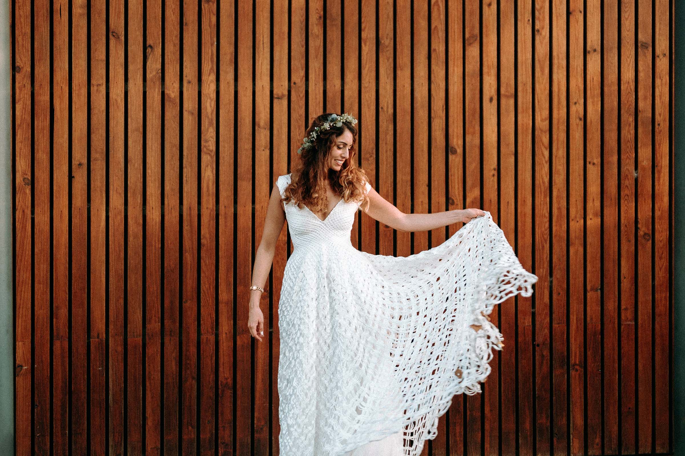 bride with alternative wedding dress against a wooden wall