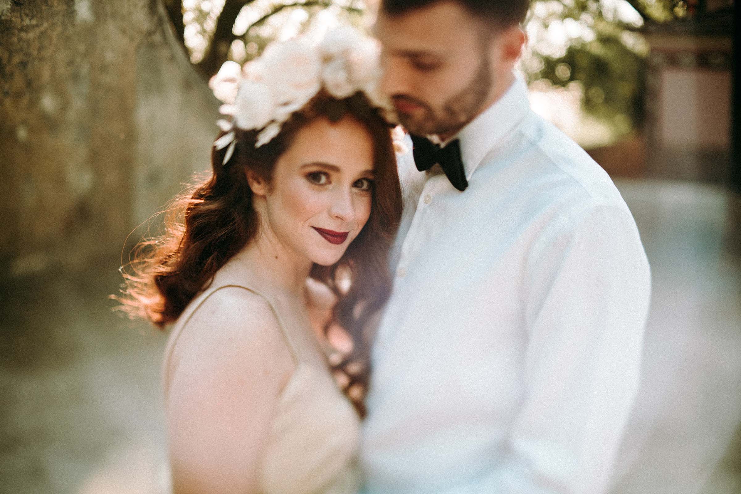 freelens bride looking straight to the camera with groom