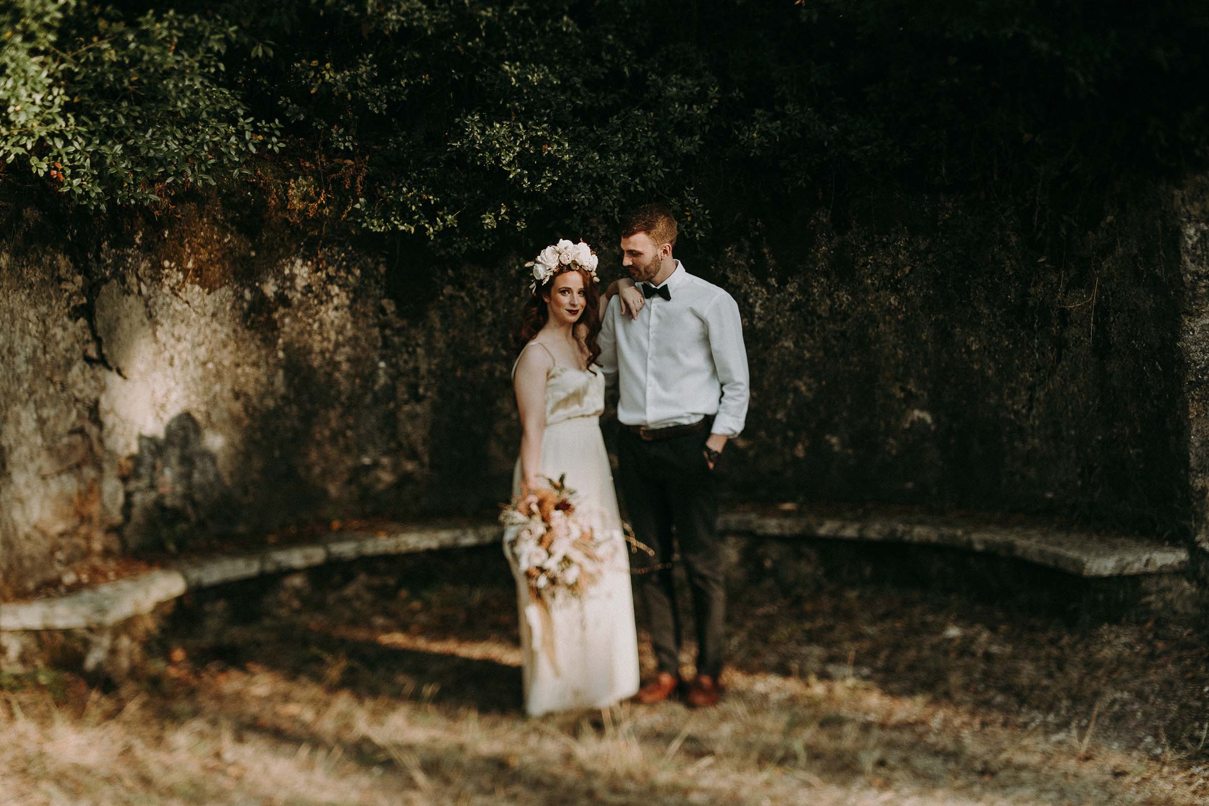 bride standing next to groom with arm on his shoulder