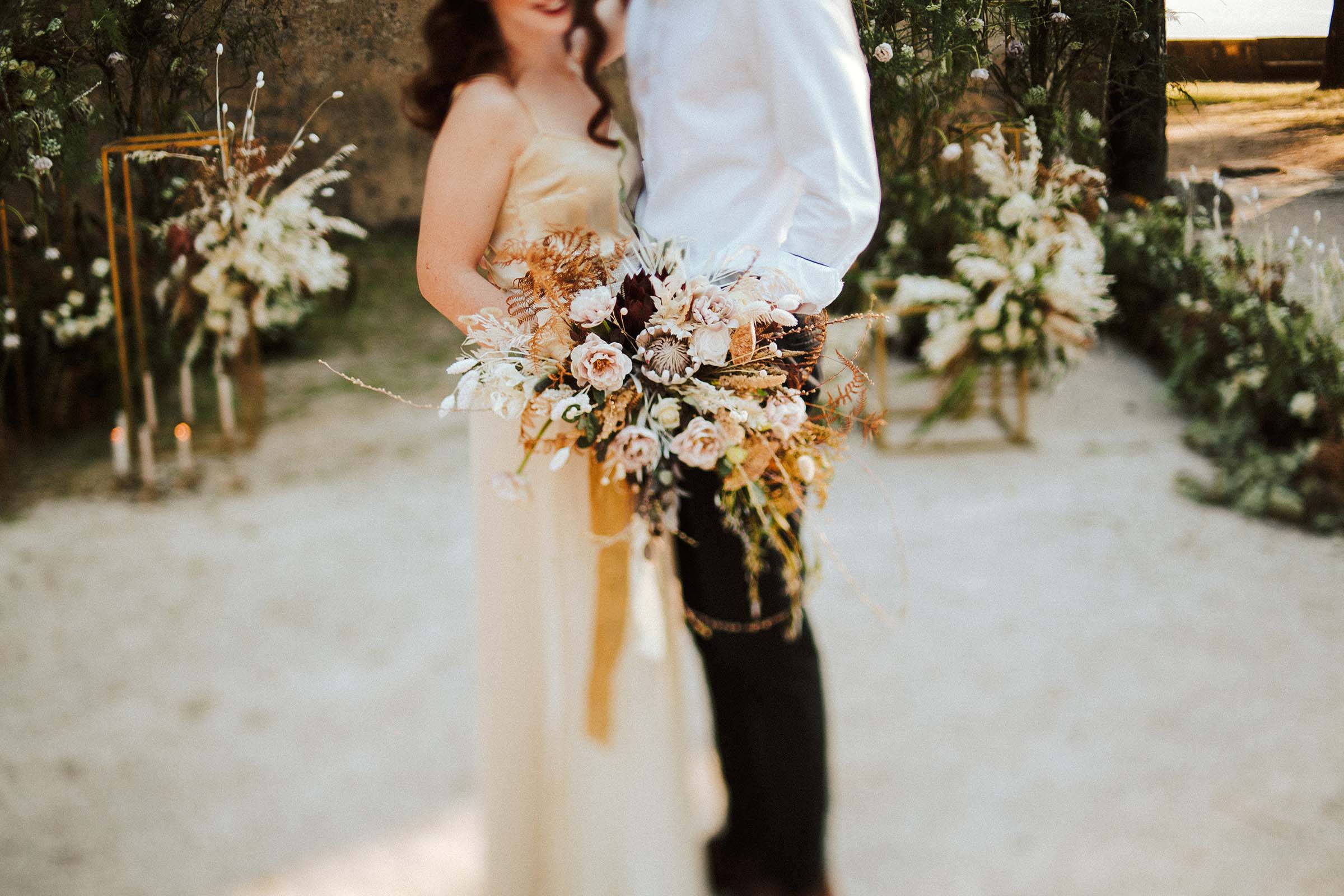 bouquet details with couple standing close together