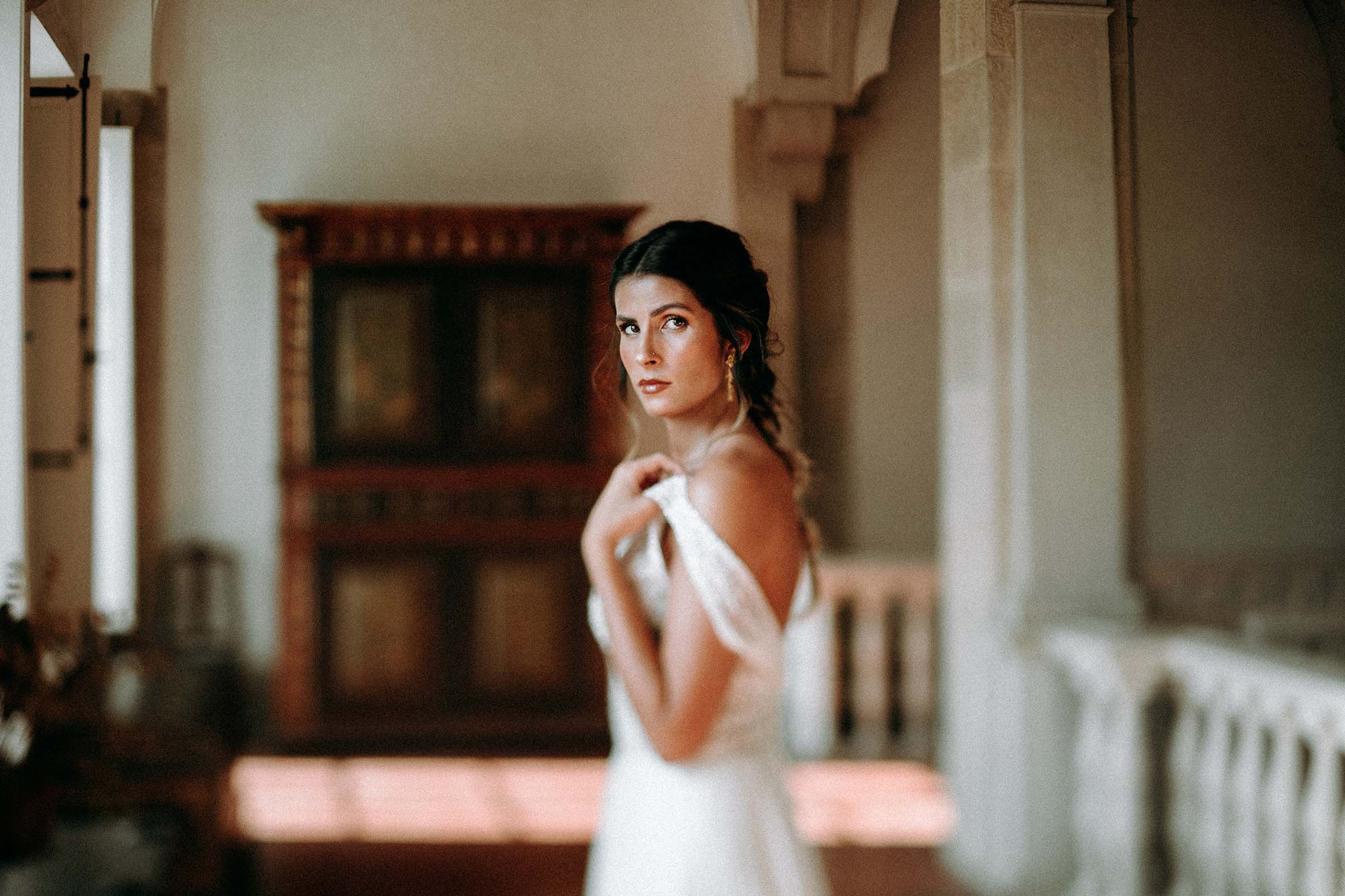 gorgeous bride pulling up wedding dress